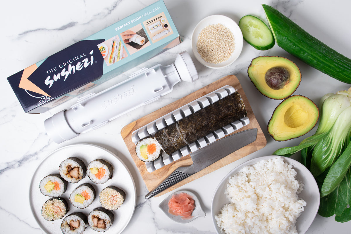 Sushezi sushi maker with fresh ingredients and finished sushi rolls